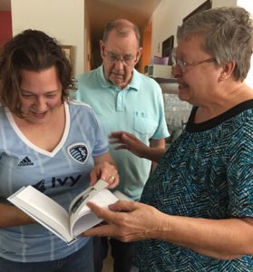 Clients give their daughter a personal history book of their life
